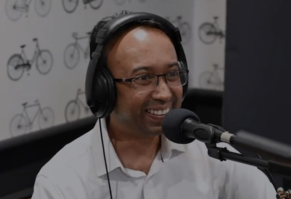 Sumith Dissanayake smiling at the microphone while recording the Books to the Boardroom podcast